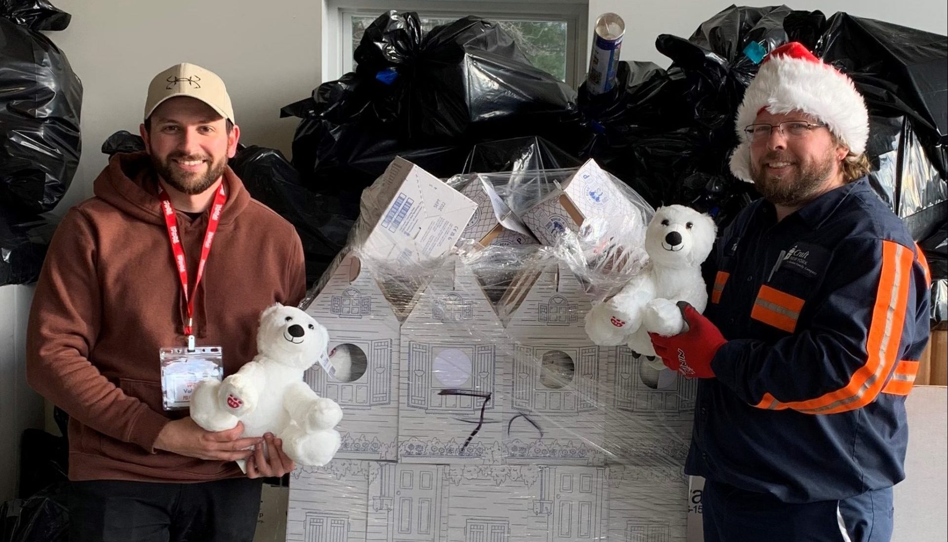 employees holding bears at Toys for Tots fundraiser
